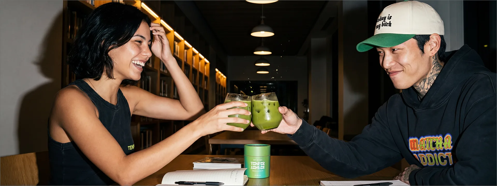 Two friends toasting with iced matcha